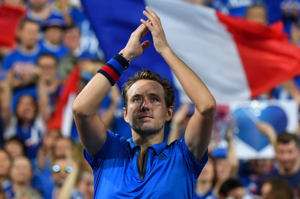 France's Lucas Pouille gestures to the crowd after victory in his singles match against Spain's Roberto Bautista-Agut in the Davis Cup semifinal tennis match between Spain and France at Villeneuve-d'Ascq, northern France, on Friday. — AFP