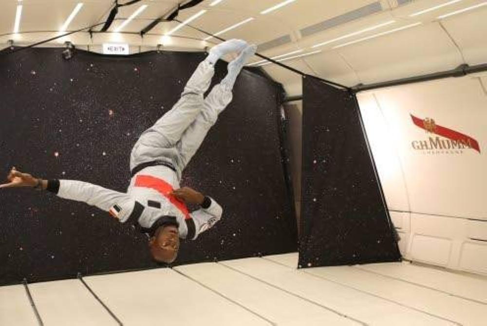 This handout photo released by Mumm/Novespace shows Jamaican retired sprinter Usain Bolt gesturing in zero-gravity conditions in an aircraft above Reims. — AFP