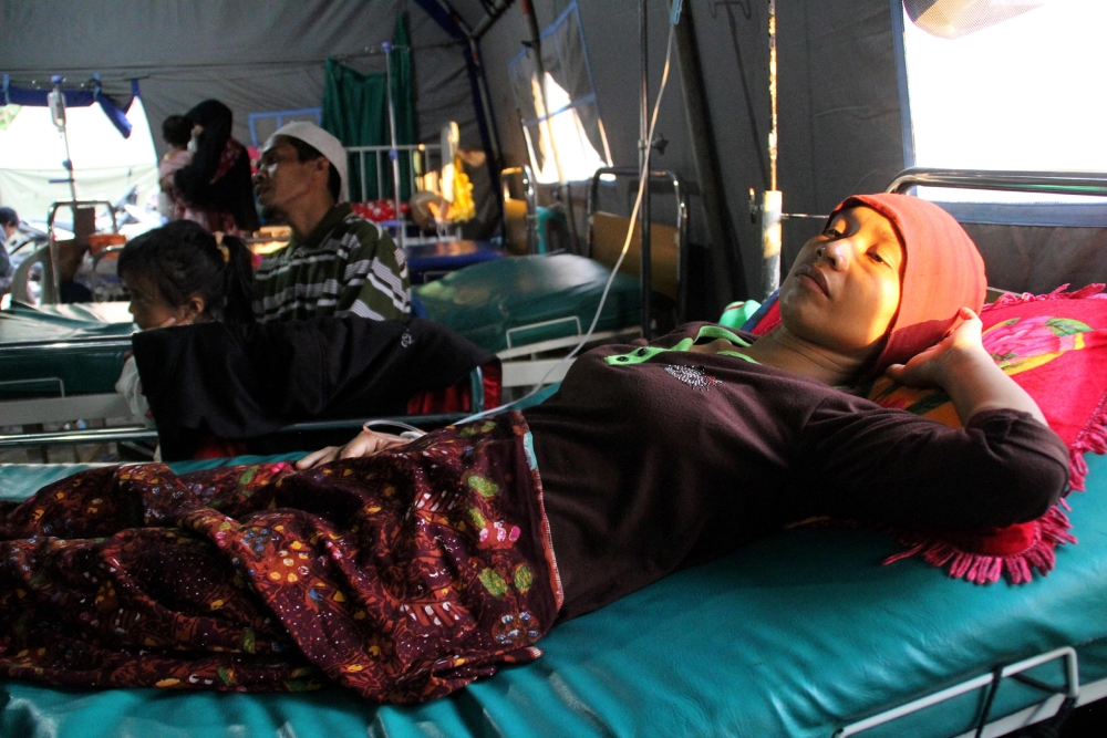 Indonesian woman Suriatun suffers from malaria at a village clinic in Gunung Sari, West Lombok.  — AFP
