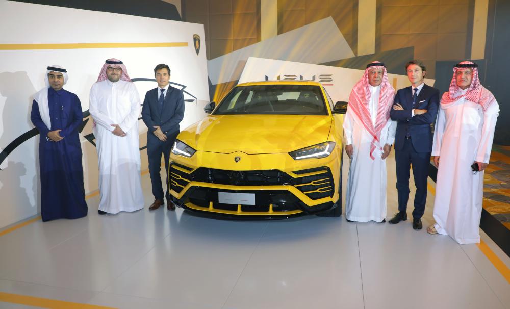 Officials of Lamborghini Jeddah and Samaco beside Lamborghini Urus during its launch