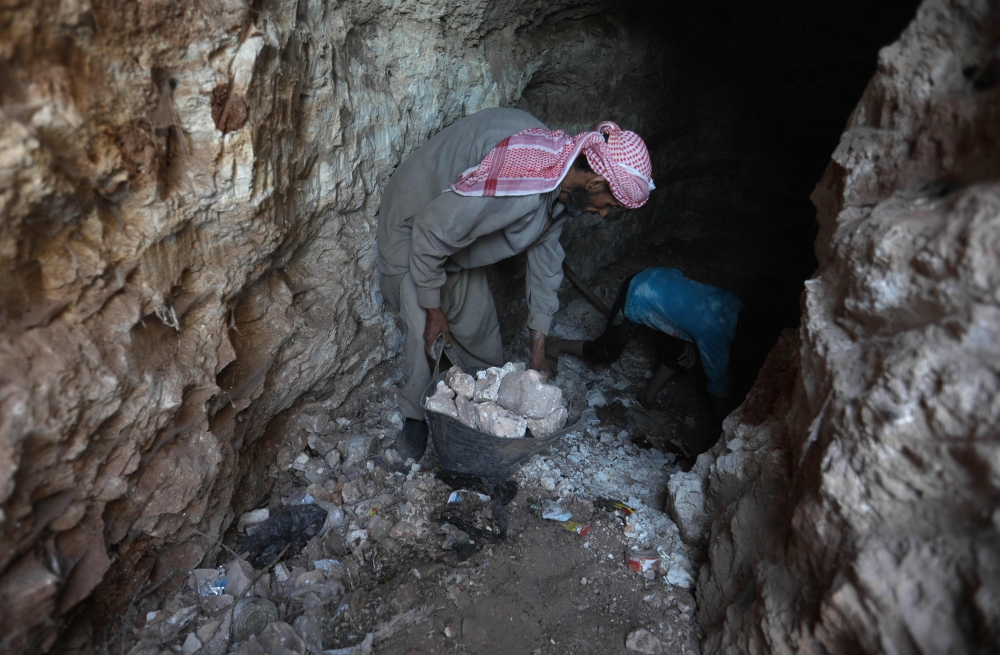 A man uses a pickaxe to dig a cave in the Syrian village of Kafr Ain in the southern countryside of the rebel-held Idlib province. — AFP