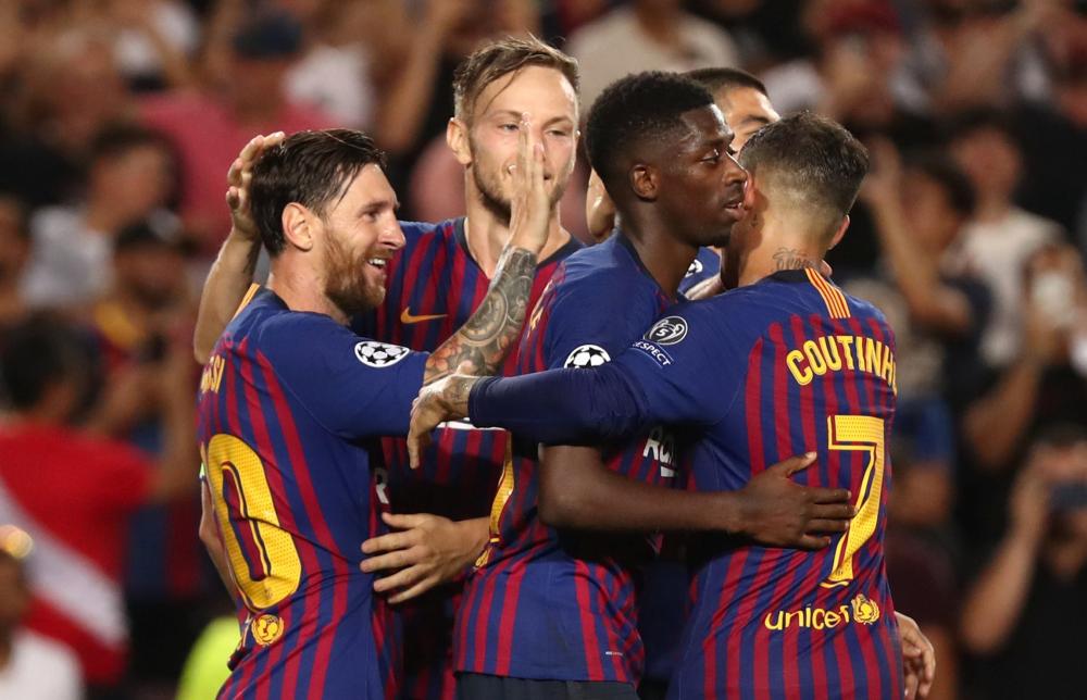 


Barcelona’s Lionel Messi celebrates with teammates after scoring against PSV Eindhoven during their Champions League match at Camp Nou, Barcelona Tuesday. — Reuters