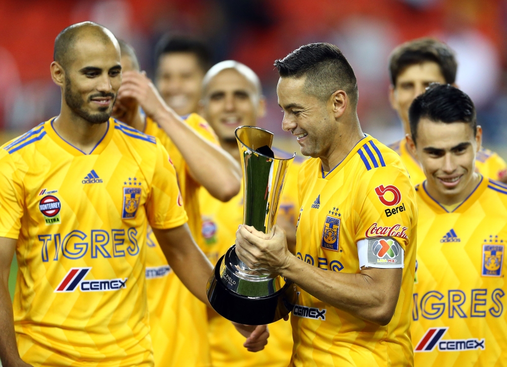 Juninho No. 3 of Tigres UANL prepares to lift the 2018 Campeones Cup Final trophy after victory against Toronto FC at BMO Field on Wednesday in Toronto, Canada. — AFP