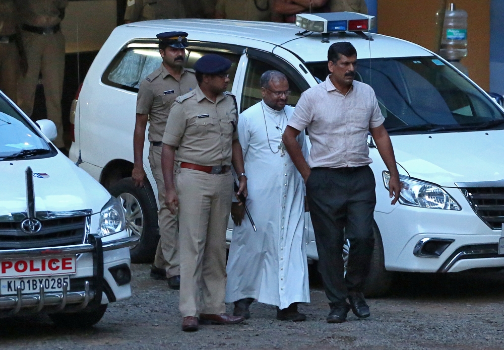 Bishop Franco Mulakkal, second right, accused of raping a nun, is pictured outside a crime branch office on the outskirts of Kochi in the southern state of Kerala, India, on Wednesday. — Reuters