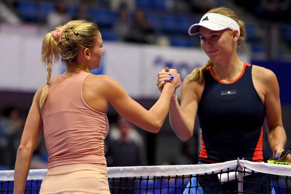 Camila Giorgi of Italy (L) is congraturated by Caroline Wozniacki of Denmark after winning their women's singles second round tennis match at the Pan Pacific Open tennis tournament in Tokyo on Thursday. — AFP