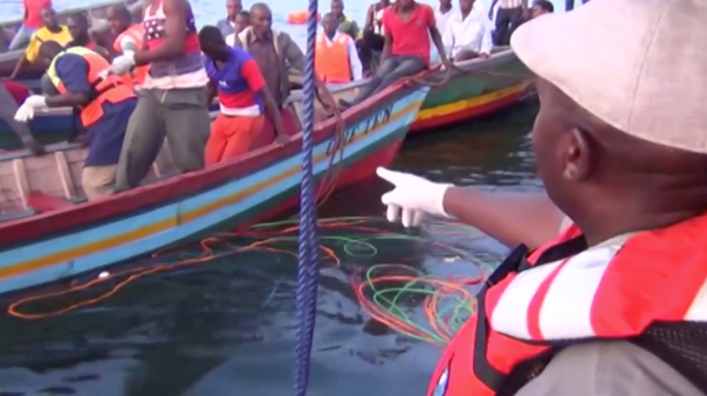Rescue workers are seen at the scene where a ferry overturned in Lake Victoria, Tanzania,  in this still image taken from video on Friday. — Reuters