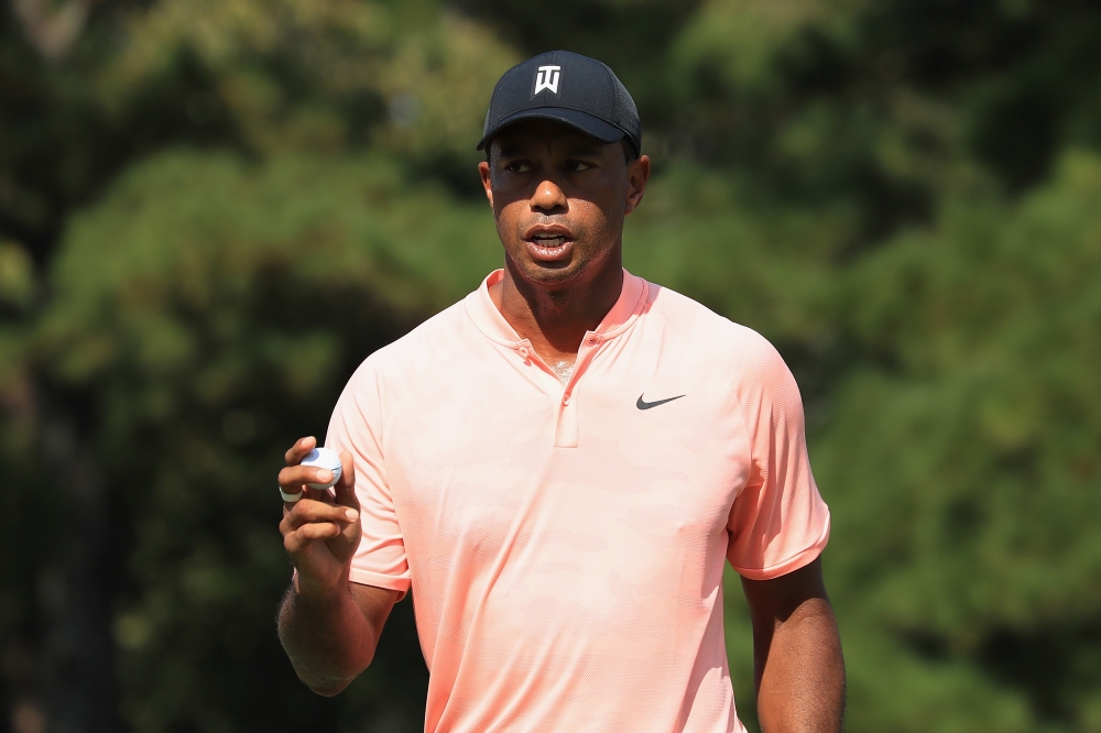 Tiger Woods acknowledges the crowd on the 16th green during the first round of the TOUR Championship at East Lake Golf Club on Thursday in Atlanta, Georgia. — AFP