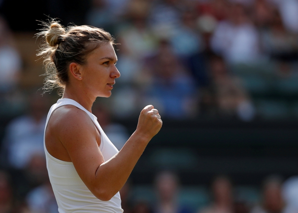 Romania's Simona Halep celebrates winning the second round match against China's Saisai Zheng during Wimbledon in this file photo. — Reuters