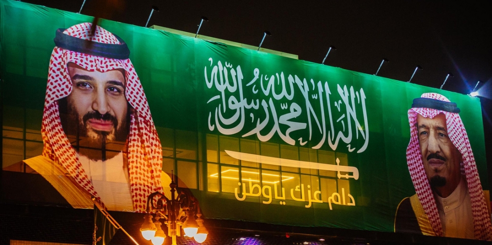 A Saudi flag with the photos of Custodian of the Two Holy Mosques King Salman and Crown Prince Muhammad Bin Salman, deputy premier and minister of defense, adorns a building on Tahlia Street in Jeddah on Saturday.
