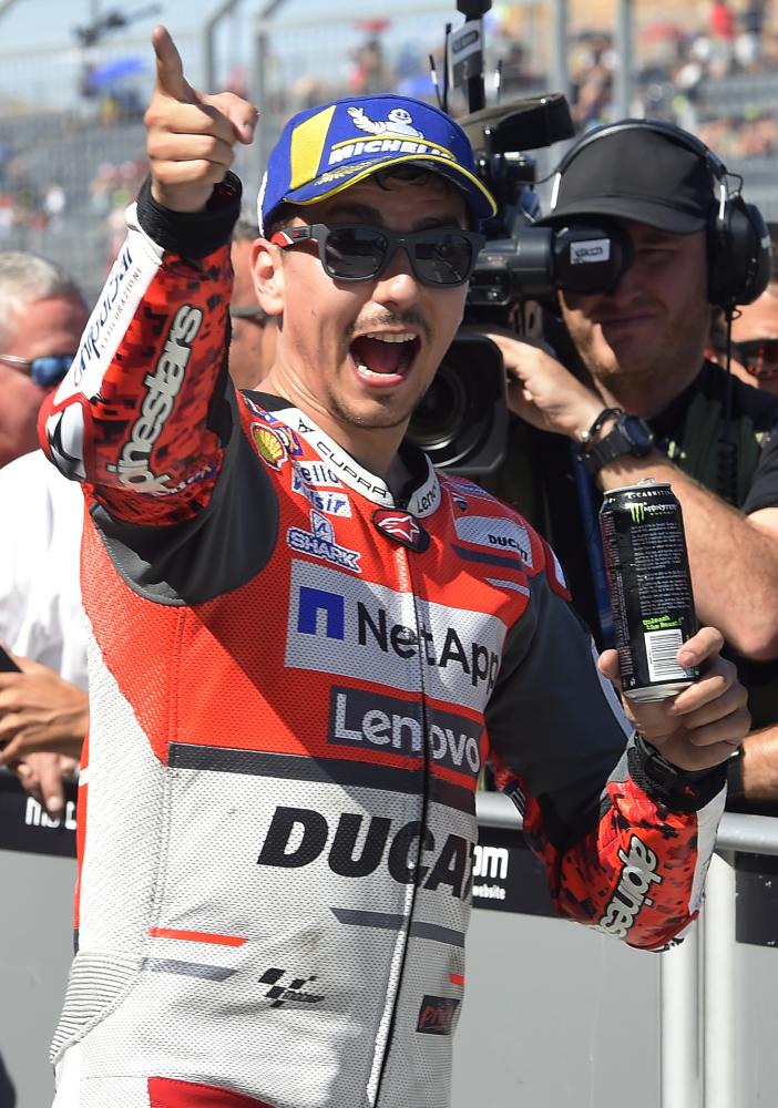 Ducati Team's Spanish rider Jorge Lorenzo celebrates clinching the 'pole' position in the MotoGP qualifier of the Aragon Grand Prix at the Motorland racetrack in Alcaniz, Spain, Saturday. — AFP