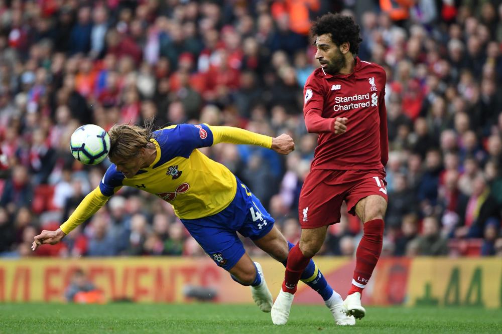 Southampton's defender Jannik Vestergaard (L) vies with Liverpool's midfielder Mohamed Salah during their English Premier League football match at Anfield in Liverpool, north west England, Saturday. – AFP