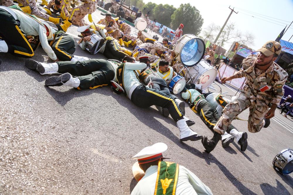 


This picture taken on Saturday in the southwestern Iranian city of Ahvaz shows a soldier running past injured comrades lying on the ground at the scene of an attack on a military parade that was marking the anniversary of the outbreak of its devastating 1980-1988 war with Iraq. — AFP