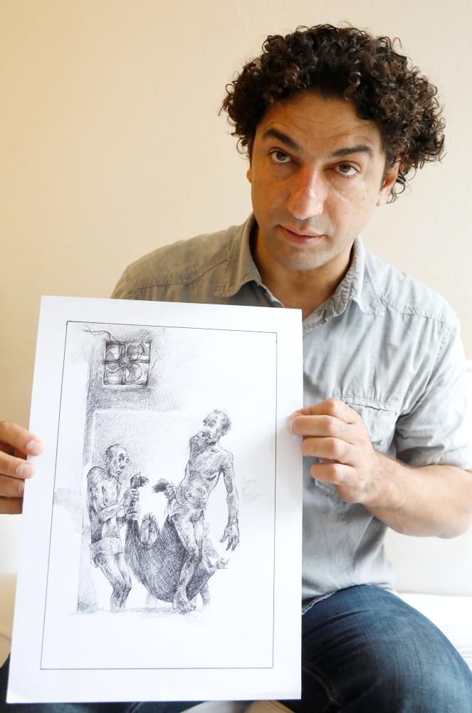 


Exiled Syrian artist Najah Al-Bukai poses with a ball-pen drawing that stems from the haunting memories of the torture Bukai says he went through and witnessed when imprisoned twice in Syrian government jails. — Reuters