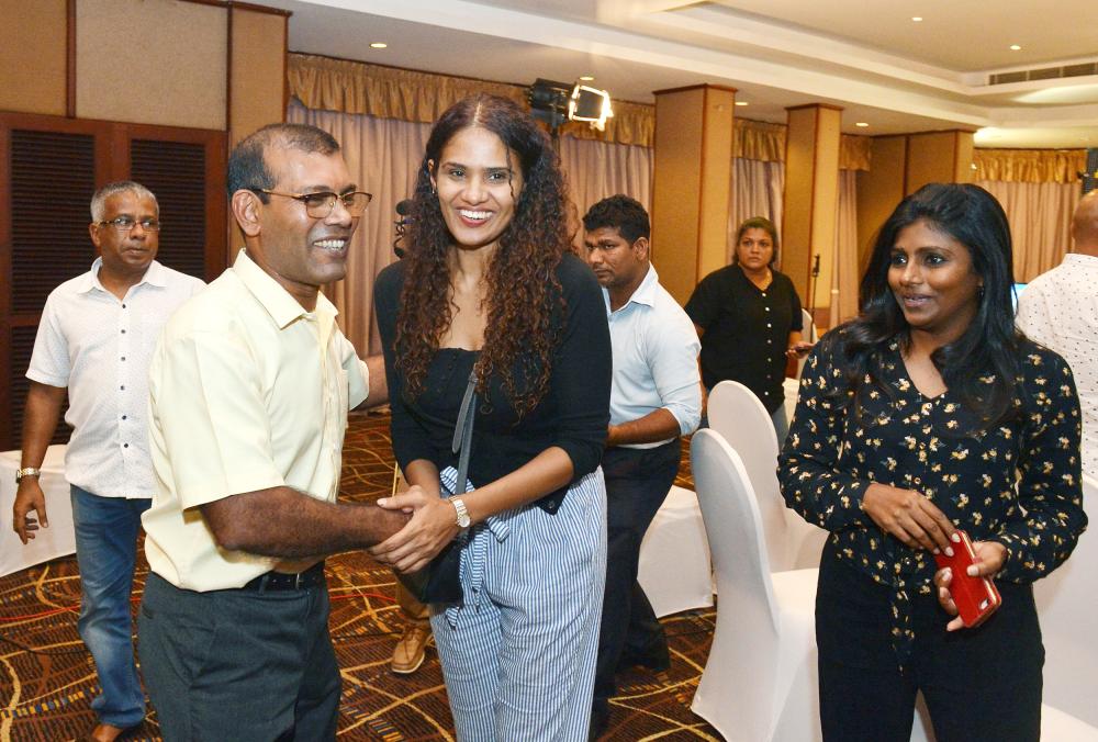 


Former president of the Maldives Mohamed Nasheed (left) is congratulated by supporters of the opposition leader and presidential candidate at a hotel in Colombo, as their candidate was set to win. — AFP