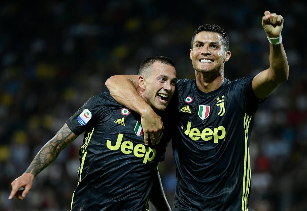 


Juventus' forward Cristiano Ronaldo (R) celebrates with teammate Federico Bernardeschi during their Italian Serie A match against Frosinone at the Benito-Stirpe Stadium in Frosinone Sunday.  — AFP 
