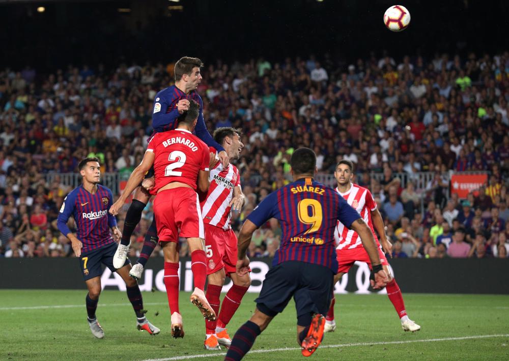 


Barcelona’s Gerard Pique scores their second goal against Girona during their La Liga match at Camp Nou, Barcelona Sunday. — Reuters