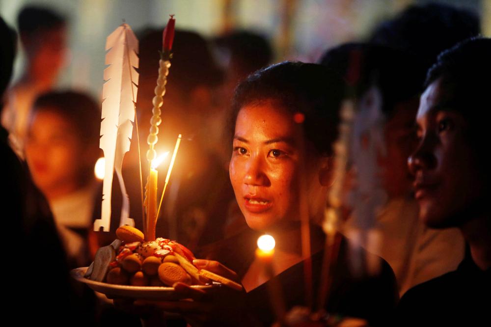 


People hold offerings while praying for loved ones who have passed away during the first day of ‘Festival of the Dead’ or Pchum Ben in Phnom Penh, Cambodia on Tuesday. - Reuters