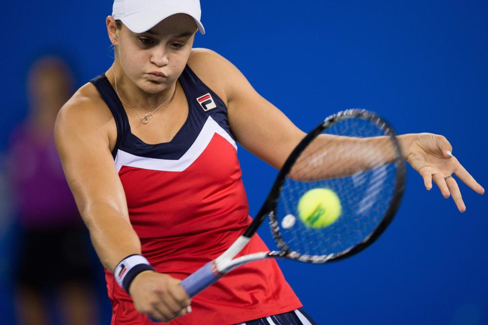 


Ashleigh Barty of Australia hits a return to Angelique Kerber of Germany at the WTA Wuhan Open Tennis Tournament Wednesday. — AFP 