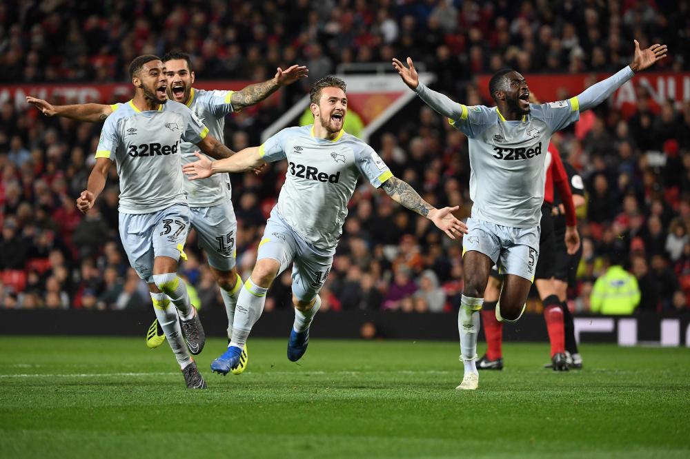 


Derby’s striker Jack Marriott (C) celebrates scoring his team’s second goal during the English League Cup third round match against Manchester United at Old Trafford in Manchester Tuesday. — AFP 
