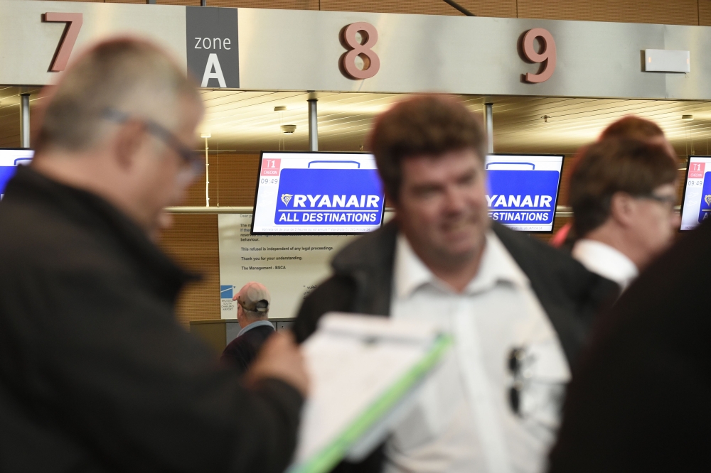 Belgium-based Ryanair pilots gather at Charleroi Airport during what could be the biggest strike in the airline's history, in Gosselies on Friday. Ryanair canceled scores of European flights as unions staged what they warned could be the biggest strike in the airline's history. The Dublin-based carrier has played down fears of widespread disruption but confirmed it would cancel nearly 250 flights. — AFP