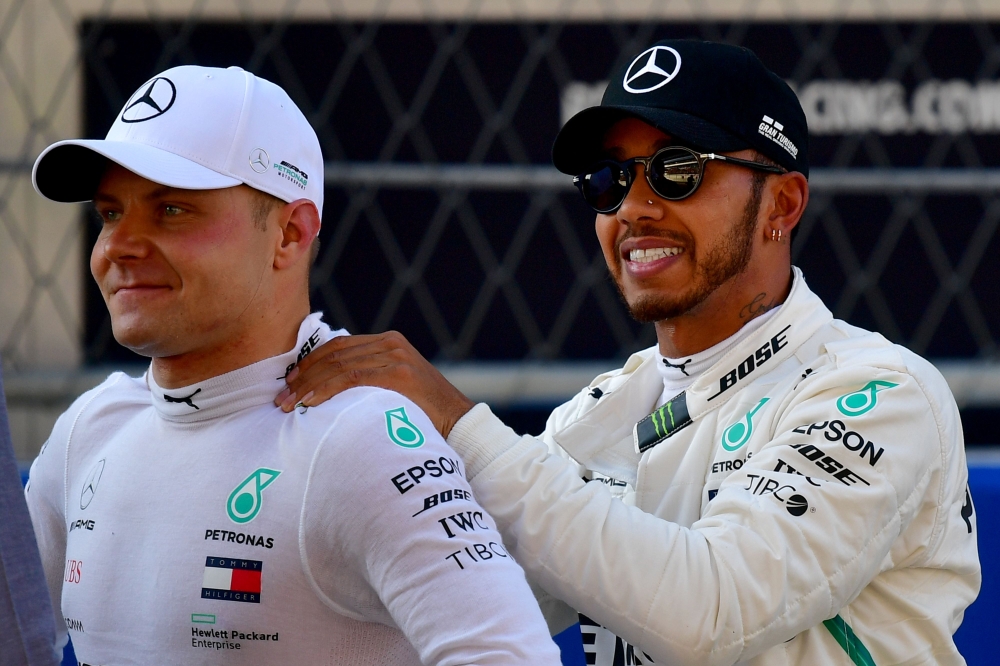 


Pole position winner Mercedes’ Finnish driver Valtteri Bottas (white cap) and second positioned Mercedes’ British driver Lewis Hamilton react after the qualifying session of the Russian Grand Prix at the Sochi Autodrom Circuit Saturday. — AFP
