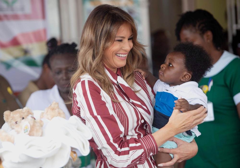 


US First Lady Melania Trump holds a baby during a visit to the Greater Accra Regional Hospital in Accra, Ghana, on Tuesday. — AFP