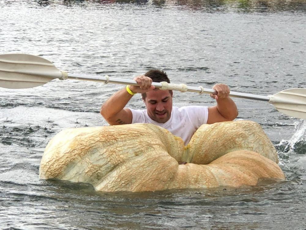 A man paddles his giant pumpkin boat during the traditional pumpkin race in Lohmar, Germany. — Reuters
