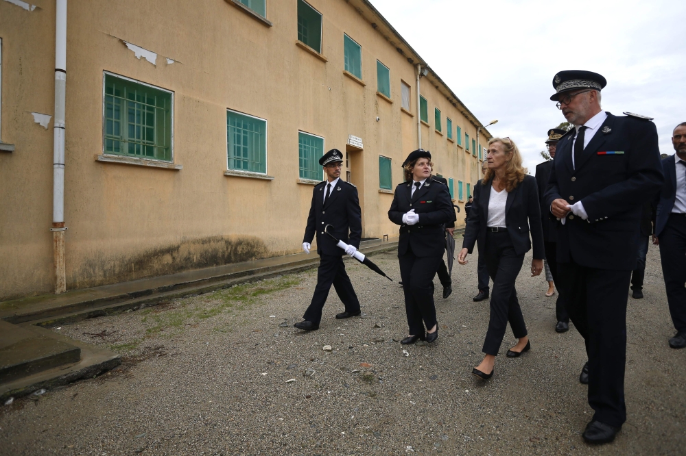 French Justice Minister Nicole Belloubet, second right, and jail director Laura Abrani, second left, visit the Casabianda open jail in Aleria on the French Mediterranean Island of Corsica in this Oct. 5, 2018 file photo. — AFP