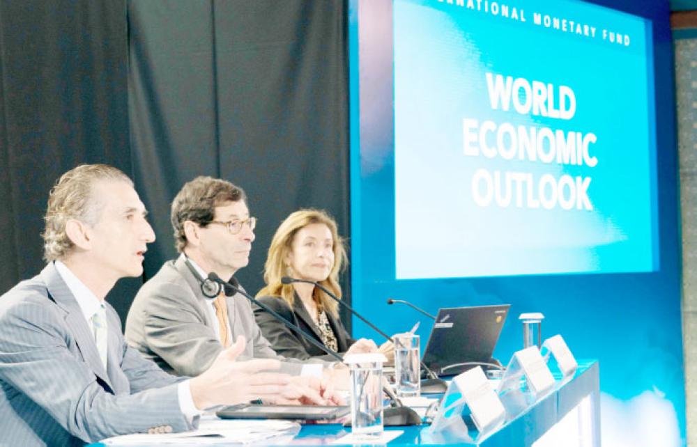 
This handout photo taken and released by the International Monetary Fund (IMF) on Tuesday shows International Monetary Fund Economic Counsellor Maurice Obstfeld (C), deputy director Gian Maria Milesi-Ferretti (L) and communications officer Wafa Amr (R) answering questions during the World Economic Outlook press conference during the 2018 IMF/World Bank annual meetings in Nusa Dua on the Indonesian resort island of Bali. — AFP