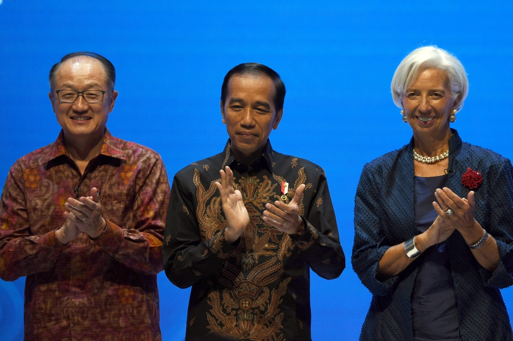 World Bank President Jim Yong Kim, Indonesia President Joko Widodo and IMF Managing Director Christine Lagarde clap their hands during attend Balifintech Seminar at International Monetary Fund-World Bank Annual Meeting 2018 in Nusa Dua, Indonesia, on Thursday. — AFP