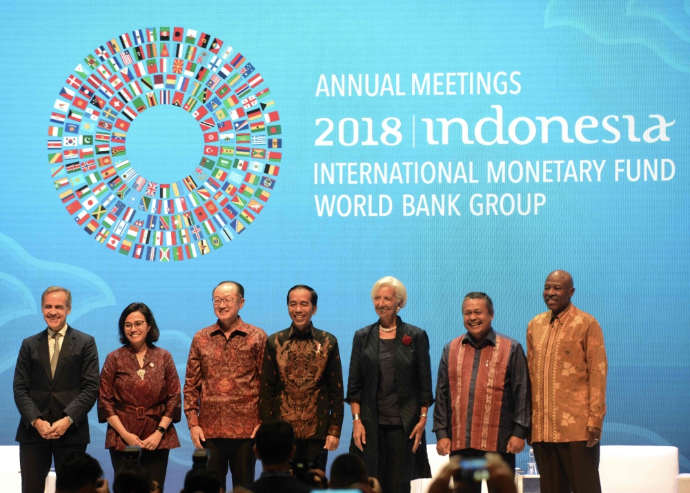 World Bank President Jim Yong Kim, Indonesia President Joko Widodo and IMF Managing Director Christine Lagarde clap their hands during attend Balifintech Seminar at International Monetary Fund-World Bank Annual Meeting 2018 in Nusa Dua, Indonesia, on Thursday. — AFP