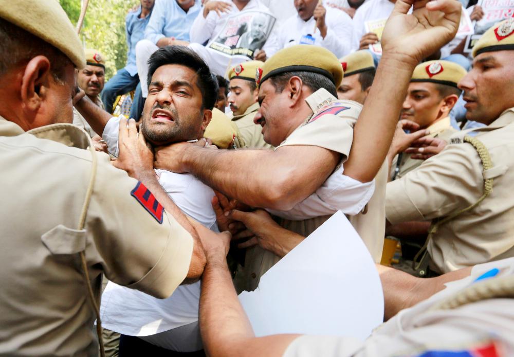 


Supporters of India’s main opposition Congress party scuffle with police during a protest demanding the resignation of India’s Minister of State for External Affairs M.J. Akbar in New Delhi, India, on Monday. — Reuters