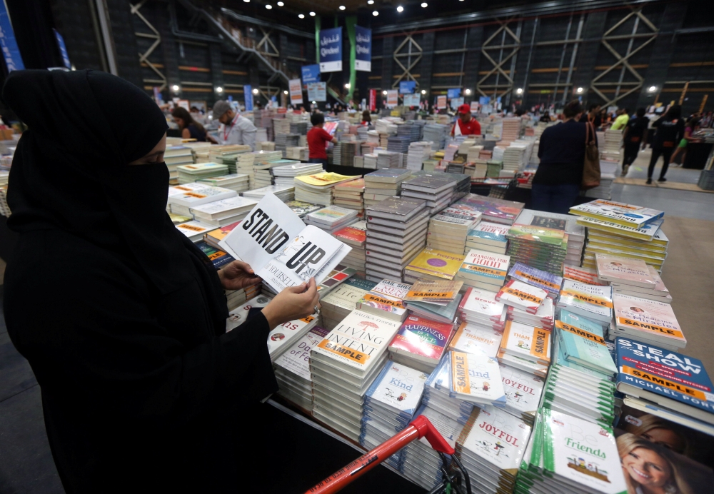 Visitors read books at the Big Bad Wolf Book Sale, which calls itself the world’s biggest, hosted for the first time by Dubai, on Wednesday. — Reuters