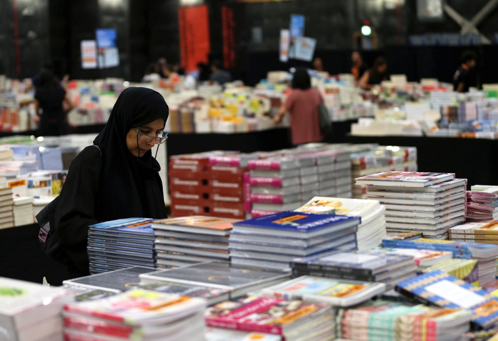 Visitors read books at the Big Bad Wolf Book Sale, which calls itself the world’s biggest, hosted for the first time by Dubai, on Wednesday. — Reuters