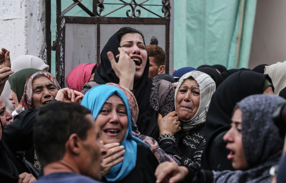 Relatives of Palestinian Naji Al-Za’aneen, 25, mourn during his funeral in the northern Gaza Strip on Wednesday. — AFP