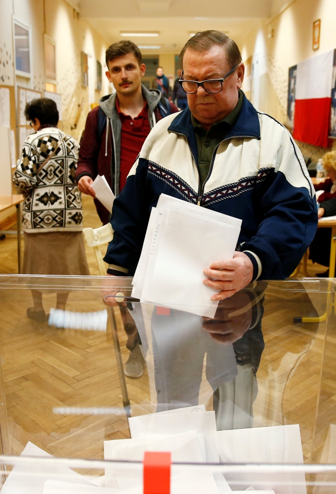 Voting underway during the Polish regional elections, at a polling station in Warsaw, Sunday. — Reuters
