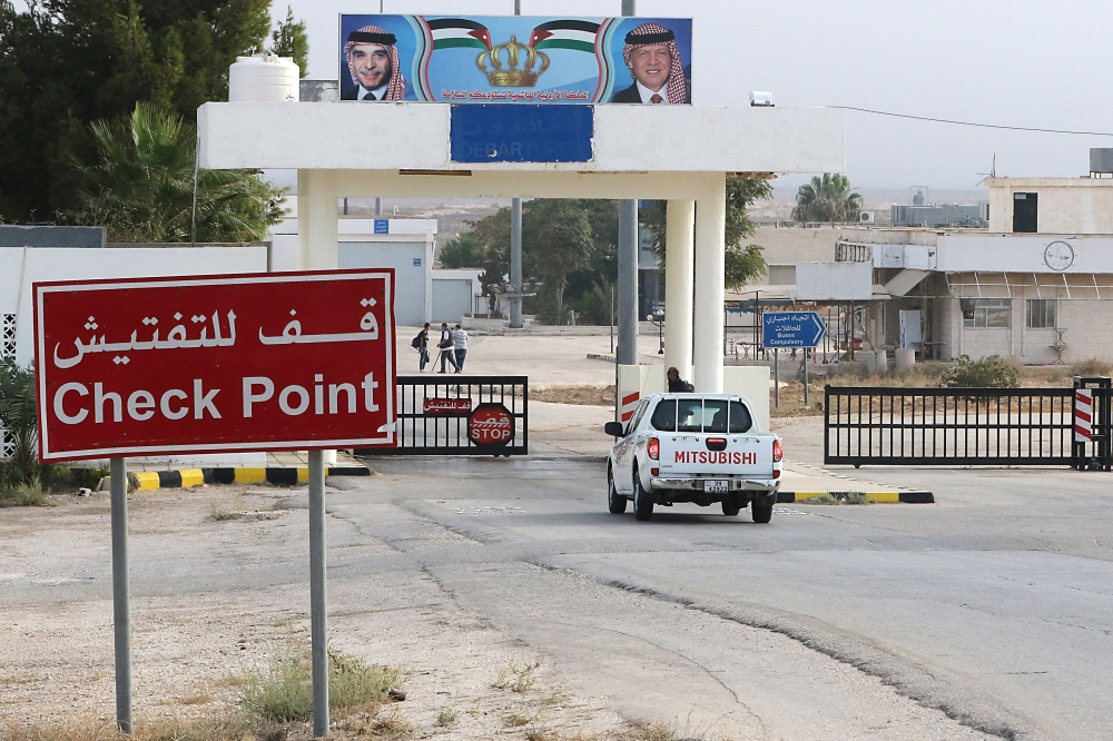 


A vehicle arrives at the Jaber border crossing between Jordan and Syria (Nassib crossing on the Syrian side) on the day of its reopening in the Jordanian Mafraq governorate last week. — AFP