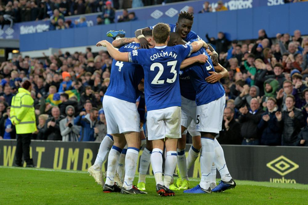 Everton players celebrate scoring against Crystal Palace during their English Premier League match at Goodison Park, Liverpool, Sunday. — Reuters