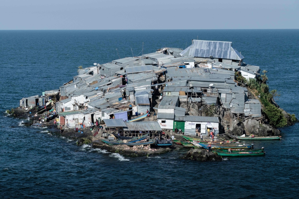 


The picture tshows a general view of Migingo island which is densely populated by residents fishing mainly for Nile perch in Lake Victoria on the border of Uganda and Kenya. A rounded rocky outcrop covered in metallic shacks, Migingo Island rises out of the waters of Lake Victoria like an iron-plated turtle. — AFP