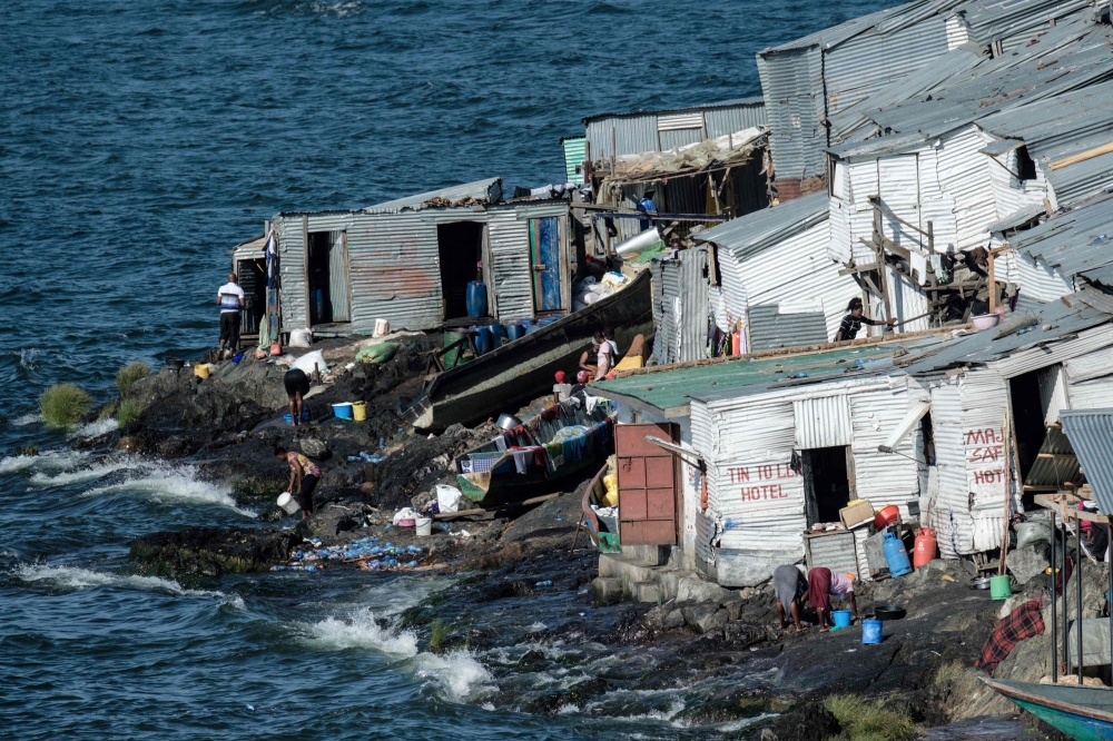 


The picture tshows a general view of Migingo island which is densely populated by residents fishing mainly for Nile perch in Lake Victoria on the border of Uganda and Kenya. A rounded rocky outcrop covered in metallic shacks, Migingo Island rises out of the waters of Lake Victoria like an iron-plated turtle. — AFP