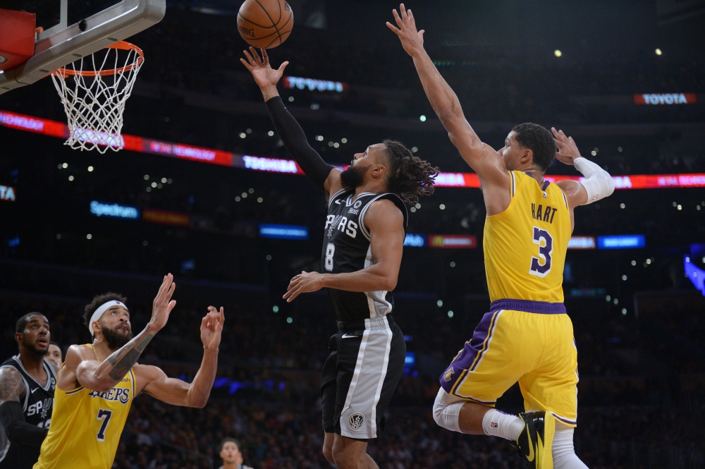 


San Antonio Spurs’ guard Patty Mills shoots against Los Angeles Lakers’ guard Josh Hart during their NBA game at Staples Center in Los Angeles Monday. — Reuters 