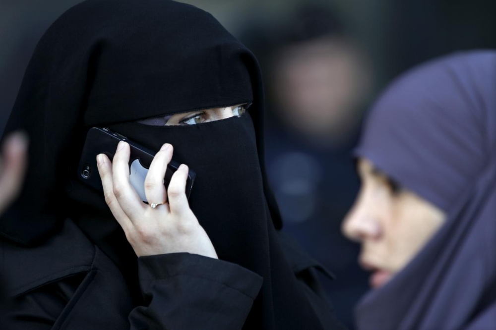 


A women wearing a niqab makes a phone call outside the courts in Meaux, east of Paris. — Reuters file photo