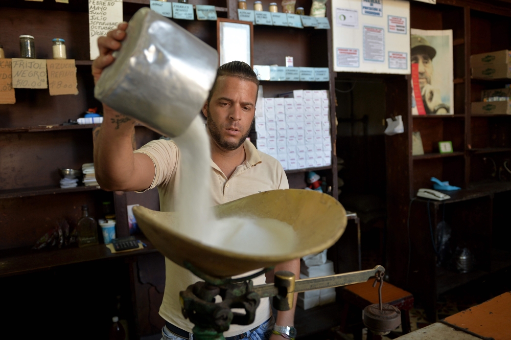 A man weighs sugar produced in France at a grocery store in Havana, Cuba, in this Oct. 9, 2018 file photo. — AFP