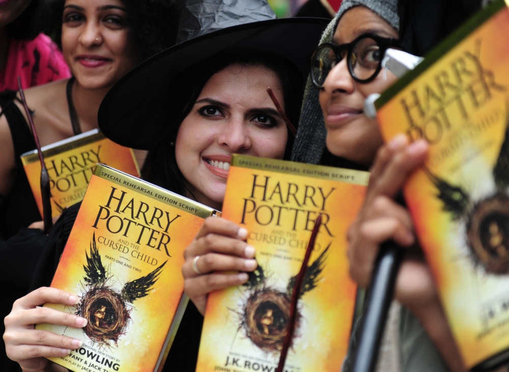 Indian girls pose for photographers with copies of J.K. Rowling’s new book ‘Harry Potter and the Cursed Child’ during an event to mark the book launch at a mall in Chennai in this July 31, 2016 file photo. — AFP