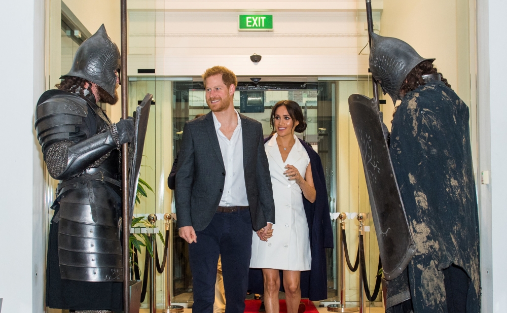 


Britain’s Prince Harry and Meghan, the Duke and Duchess of Sussex, are greeted by actors in costume as they arrive for a visit to Courtenay Creative, in Wellington, New Zealand, Monday. — Reuters