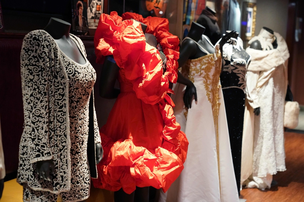 This combination of photos released by Julien's Auctions shows various outfits belonging to the late singer Aretha Franklin. More than 30 dresses and accessories worn on stage by Aretha Franklin are going up for auction on Nov. 10. The items will go on display between Nov. 5 and Nov. 9. at the Hard Rock Cafe in New York. 