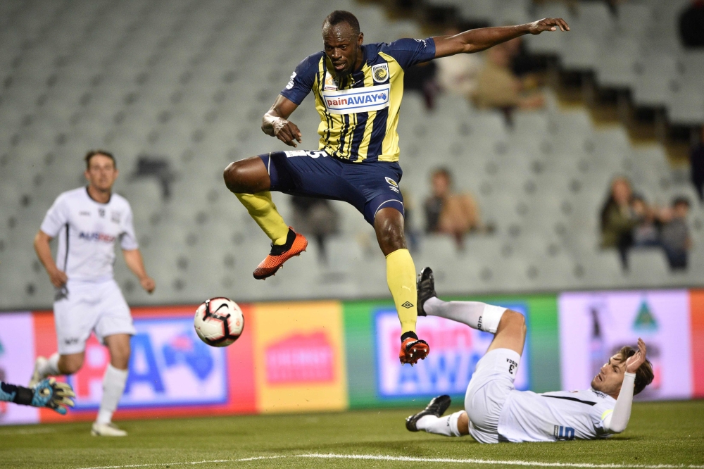This file photo shows Olympic sprinter Usain Bolt, playing for A-League football club Central Coast Mariners, jumping while controlling the ball in his first competitive start for the club against Macarthur South West United in Sydney. — AFP