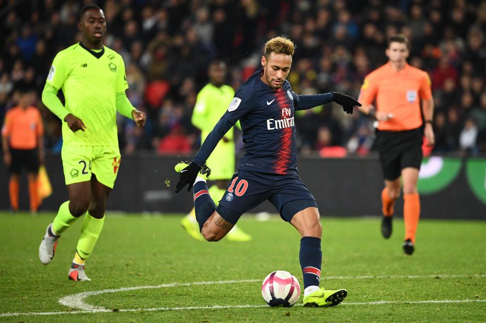 


Paris Saint-Germain’s Neymar shoots and scores a goal during their French L1 football match against Lille at the Parc des Princes Stadium in Paris Friday. — AFP