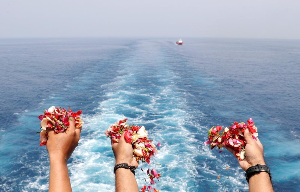 


Families and colleagues of passengers and crew of Lion Air flight JT610 throw flowers and petals from the deck of Indonesia Navy ship KRI Banjarmasin as they visit the site of the crash to pay their tribute, at the north coast of Karawang, Indonesia, on Tuesday. — Reuters