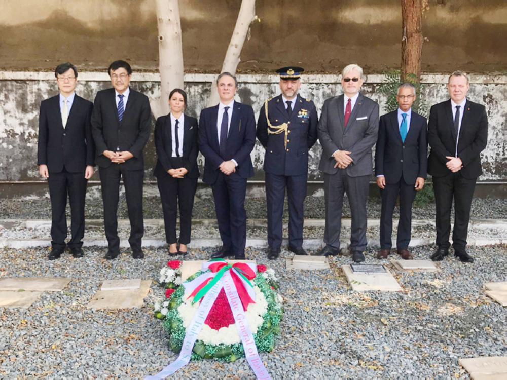 A group picture for Italy’s Ambassador Luca Ferrari alongside other diplomats at the cemetery. 